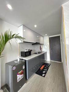 a kitchen with white cabinets and a stove top oven at Comfy studio near yaya Kilimani in Nairobi