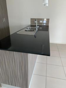 a black counter with a sink in a bathroom at Grace Guest Rooms in Roma