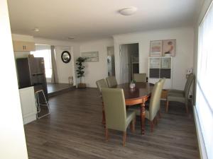 a dining room and living room with a table and chairs at Seaview Retreat in Tiddy Widdy