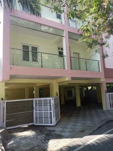 a pink building with a gate in front of it at THE POSH RESIDENCY, ECR in Chennai