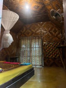 a room with a bed and a ceiling with a window at Sanctuary Lanta in Ko Lanta