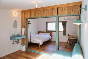 a bedroom with a bed and a sink and a mirror at palette in Numazu
