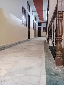 an empty corridor of a building with a column at Om Sai palace in Chandīgarh