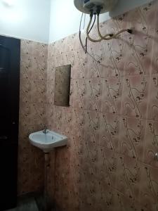 y baño con lavabo y espejo. en Om Sai palace, en Chandīgarh