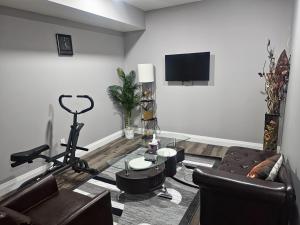 a living room with a couch and a flat screen tv at Cozy Basement Suite - private entrance - Free Netflix in Edmonton