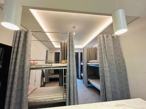 a room with two bunk beds and a hallway with curtains at OVAL TOWER in Dubai