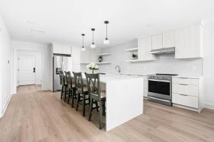 a kitchen with white cabinets and a table and chairs at Evans-Clark Manor in Indianapolis