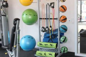 a gym with balls and exercise equipment on a wall at 4 mi to Jack Thrice Stadium + amenities in Ames