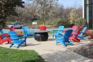 a group of colorful chairs around a table at Onsite coffee bar just mins to Jack Thrice Stadium in Ames