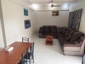 a living room with a couch and a table at Double bed in Nadi