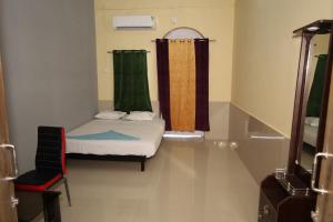 a small room with a bed and a window at RAIL NEST in Kharagpur