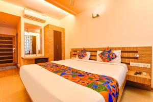 a bedroom with a large bed in a room at FabHotel Apex Intercontinental in Jaipur