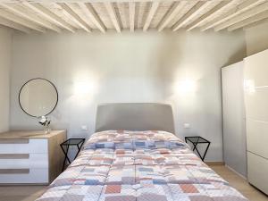 a bedroom with a bed and a dresser and a mirror at Casa Lore in Pontedera