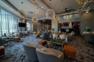 哥打巴魯的住宿－Renai Hotel Kota Bharu，带沙发的酒店大堂和酒吧