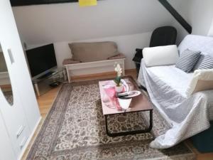 a living room with a coffee table and a couch at Sauerland Holiday House in Olsberg +17 photos