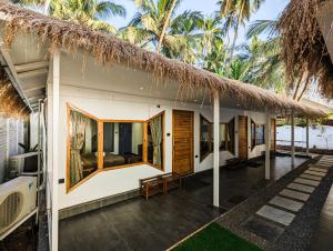 a villa with a view of the ocean at Aqua Beach Resort Ashwem in Mandrem