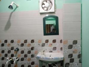 a bathroom with a sink and a mirror at Super OYO Flagship Sofitel Hotel in Dhanbād