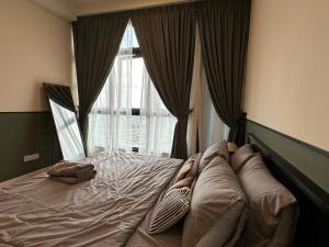 a bed in a bedroom with a large window at Paradigm Residence Studio 4pax 2King bed Netflix WiFi in Johor Bahru