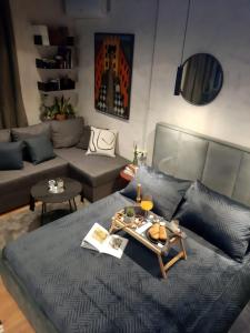 a living room with a bed and a couch at City Center Tirana Urban Condo in Tirana