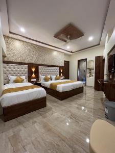 a large bedroom with two beds in a room at Hotel Imperial in Mumbai