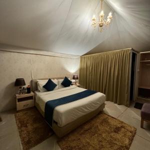 a bedroom with a bed and a chandelier at Shivjot Farm & Resort Panchkula in Panchkula