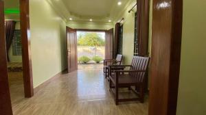 a hallway with a table and chairs in a house at Serei Saophoan Villa Homestay in Sisophon 