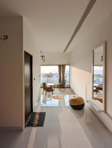a living room with white walls and a large window at Aqua Beach Resort Ashwem in Mandrem