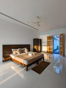 a bedroom with a large bed in a room at Aqua Beach Rooms, only accommodation on Ashwem Beach in Mandrem
