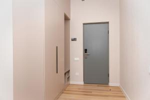 an empty corridor with a door in a room at Aston Hotel in Aktau