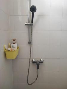 a shower with a shower head in a bathroom at บ้านพักในสวนK&N2 