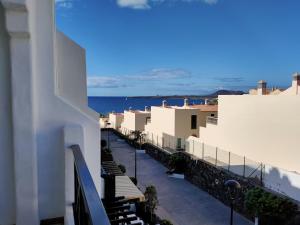 Una vista del océano desde el balcón de un edificio. en Rocas del Mar 327, en Costa del Silencio