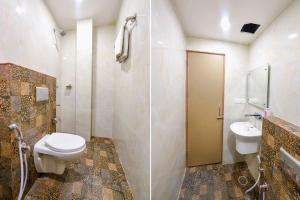 a bathroom with a toilet and a sink at FabHotel Nirvana Grand By IO in Amritsar