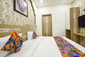 a hotel room with a bed and a tv at FabHotel Nirvana Grand By IO in Amritsar