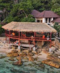 a building with a roof on top of the water at Tao Thong Villa 2 in Koh Tao