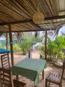 a table and two chairs under a wooden umbrella at Ananda Home Stay and Restaurant in Tangalle
