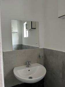 a white sink in a bathroom with a mirror at Goshen in Johannesburg