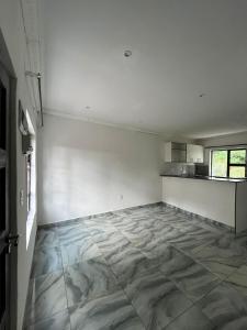 an empty room with white walls and a tile floor at Goshen in Johannesburg