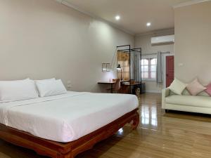 a bedroom with a large white bed and a couch at Funwan Hotel in Li