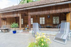 two blue chairs sitting outside of a building at Ferienwohnungen Handwerger in Hollfeld
