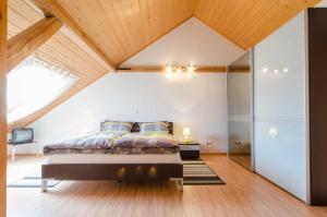 a bedroom with a bed in a attic at Ferienwohnungen Handwerger in Hollfeld