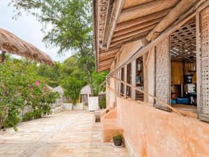 an outside view of a building with a porch at Café Gili Beach Bungalows in Gili Meno