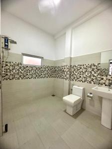 a bathroom with a toilet and a sink at Lagoon Step Transit Hotel in Katunayaka