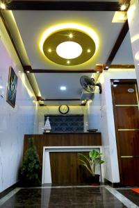 a living room with a large circular light on the ceiling at JP RESIDENCY in Yelagiri