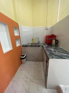 a kitchen with a sink and a counter top at Tony's Homestay in Ấp Thiện Phước