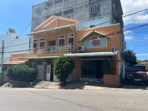 an orange building with a sign in front of it at Tony's Homestay in Ấp Thiện Phước