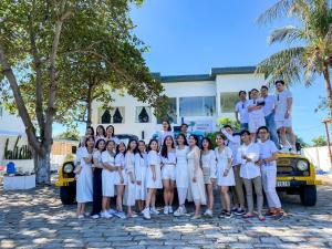 a group of people posing for a picture in front of a car at Evergreen Tree Homestay in Phan Thiet +58 photos