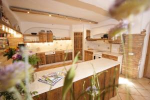 a large kitchen with wooden cabinets and a counter top at Wolfeicherhof in Eggstätt