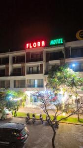 a hotel with motorcycles parked in a parking lot at night at FLORA Hotel Phu Quoc in Phu Quoc