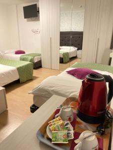 Zimmer mit einem Tisch und einem Wasserkocher in der Unterkunft Hotel B&B Lorenzini Ski in Selva di Cadore