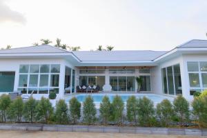 a house with a pool in front of it at Gems Pool Villa Chanthaburi in Chanthaburi